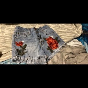 jean shorts with roses , high rise wore for half a day . Fit more like a 3
